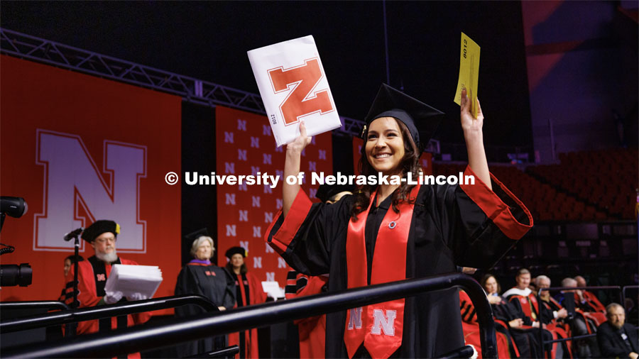 Leslie Castaneda, a graduate in Criminology and Criminal Justice, smiles as she walks across stage. Winter Undergraduate Commencement in Pinnacle Bank Arena. December 17, 2022. Photo by Craig Chandler / University Communication.