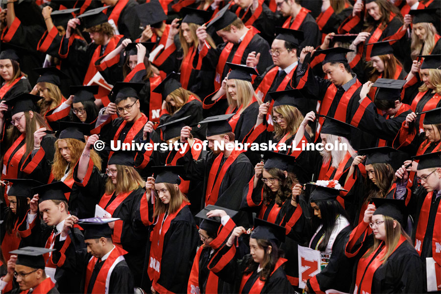 Graduates move their tassels from right to left to signify their graduation. Winter Undergraduate Commencement in Pinnacle Bank Arena. December 17, 2022. Photo by Craig Chandler / University Communication.