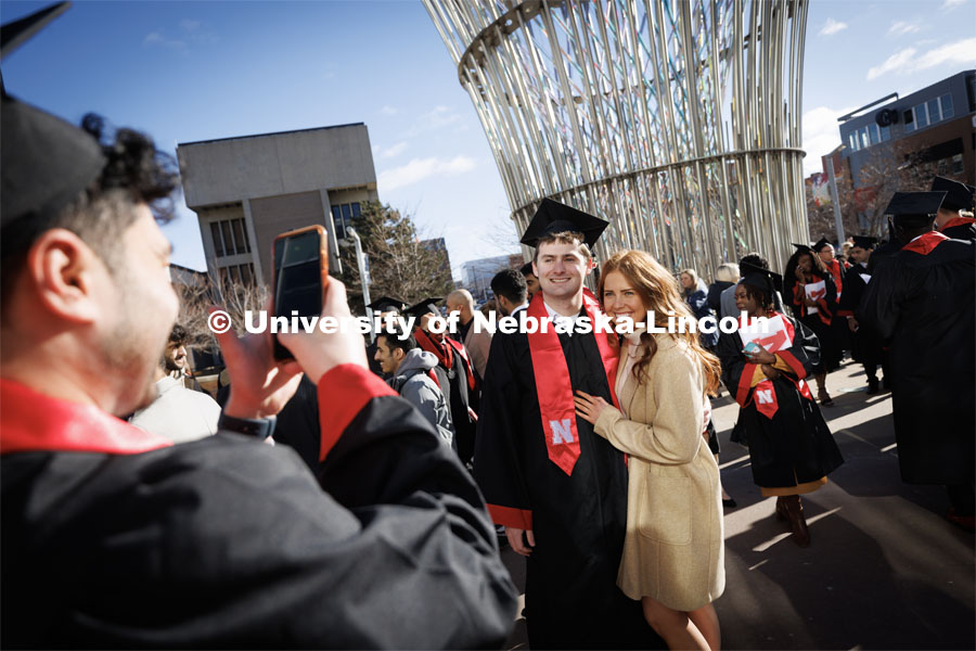 Dayne Kreikemeier, a Civil Engineering graduate, and Ally Becker pose for photos after commencement. Winter Undergraduate Commencement in Pinnacle Bank Arena. December 17, 2022. Photo by Craig Chandler / University Communication.