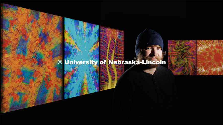 Sage Reiger, a videographer/editor with Nebraska Public Media, has synesthesia and his brain processes music as colors.  He has produced artwork to show what he hears. His musical artwork from left are: Bob Dylan’s Stuck Inside of Mobile with the Memphis Blues Again, Denzel Curry’s Melt Session #1, Porter Robinson’s Musician, Phil Collins’ In the Air Tonight and Injury Reserve’s Superman That. December 19, 2022. Photo by Craig Chandler / University Communication.