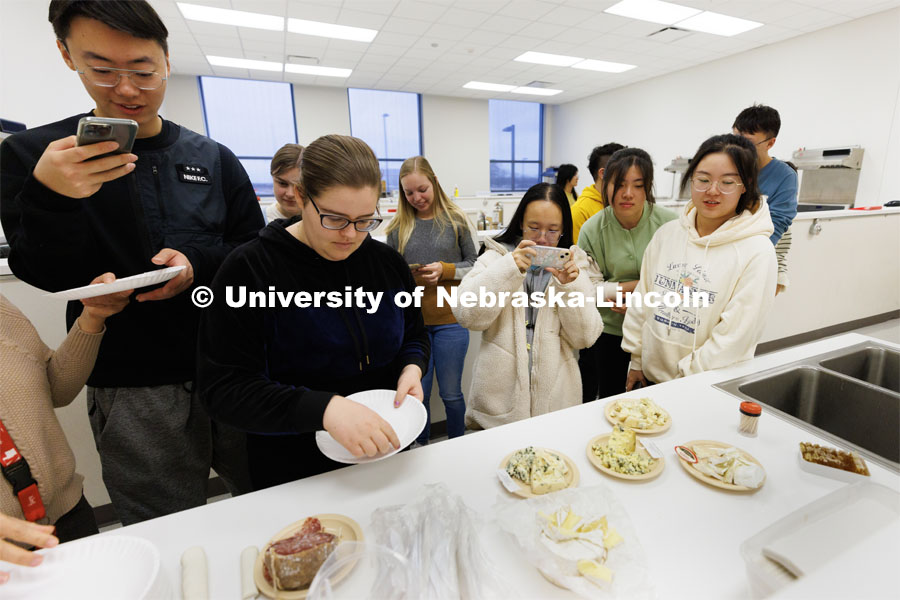 Students in Heather Hallen-Adams’ FDST 492 - Special Topics in Food Science and Technology topic Moldy Meals: Koji and More line up to sample various moldy cheeses and sausage. January 10, 2023. Photo by Craig Chandler / University Communication.