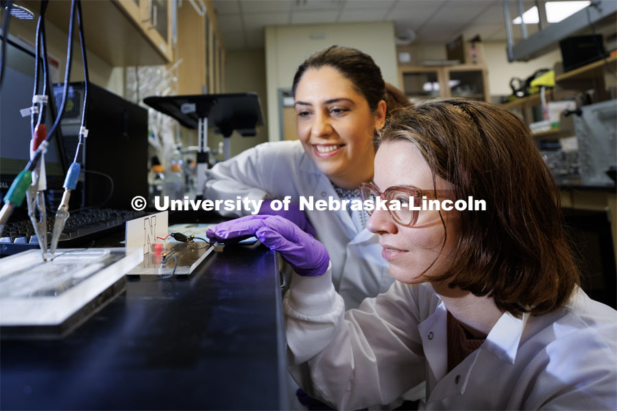 Mona Bavarian, Assistant Professor in Chemical & Biomolecular Engineering, is a CAREER winner. She and Alyssa Grube, a graduate student researcher, look over Grube’s MXene-coated textile-based supercapacitors for energy generation and storage for apparel. February 7, 2023. Photo by Craig Chandler / University Communication.