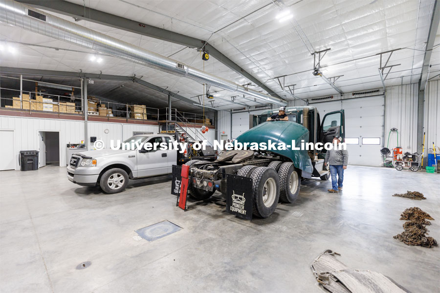 Jeff Hornung talks with employee Kelton Walz in the shop as Walz works to recondition a 2019 Kenworth for resale. Hornung and his Pioneer Equipment business in Hastings, Nebraska. Hornung is a former Engler student and has grown his business selling used large trucks world wide. February 21, 2023. Photo by Craig Chandler / University Communication.