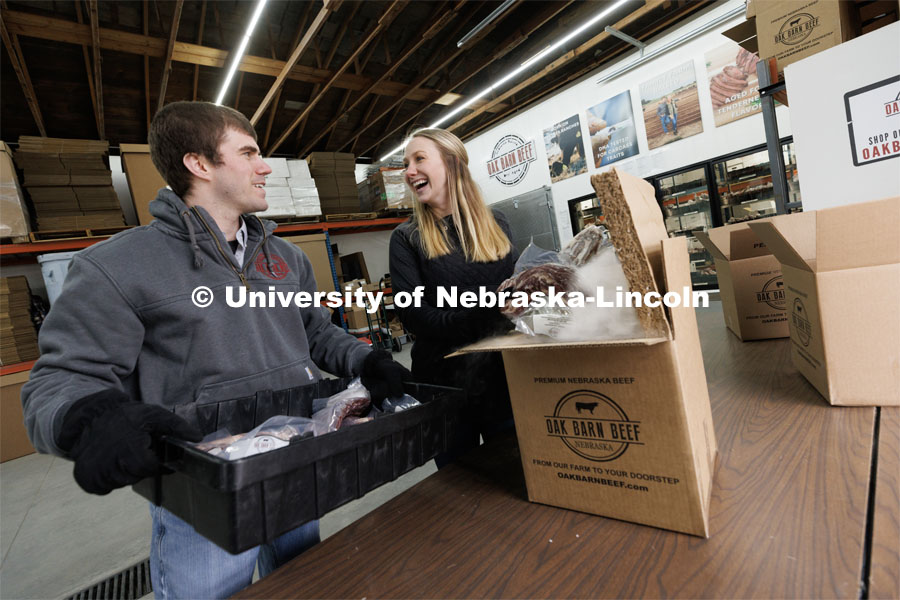 Hannah and Eric Klitz, both Engler alumni, share a laugh as they pack an order for shipment from the Oak Barn Beef store in West Point, Nebraska. Hannah started the company as a sophomore Engler student. They now ship orders to all 50 states. The beef orders are shipped around the country packed in dry ice. February 21, 2023. Photo by Craig Chandler / University Communication.