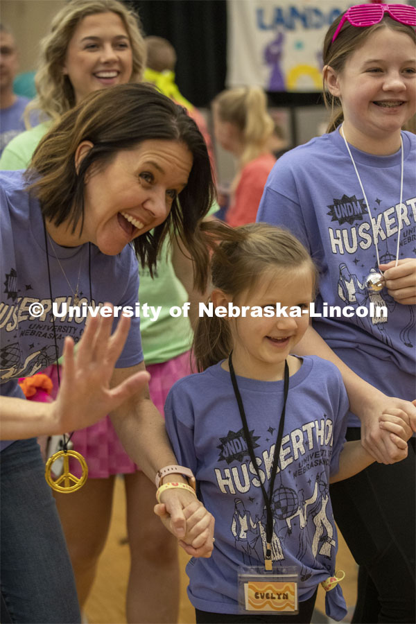 Evelyn Greisen smiles with her mother during Miracle Kid procession at Huskerthon 2023. University of Nebraska–Lincoln students raised $118,208 during the annual HuskerThon on Feb. 25. Also known as Dance Marathon, the event is part of a nationwide fundraiser supporting Children’s Miracle Network Hospitals. The annual event, which launched in 2006, is the largest student philanthropic event on campus. The mission of the event encourages participants to, “dance for those who can’t.” All funds collected by the Huskers benefit the Children’s Hospital and Medical Center in Omaha. February 25, 2023. Photo by Blaney Dreifurst for University Communication.