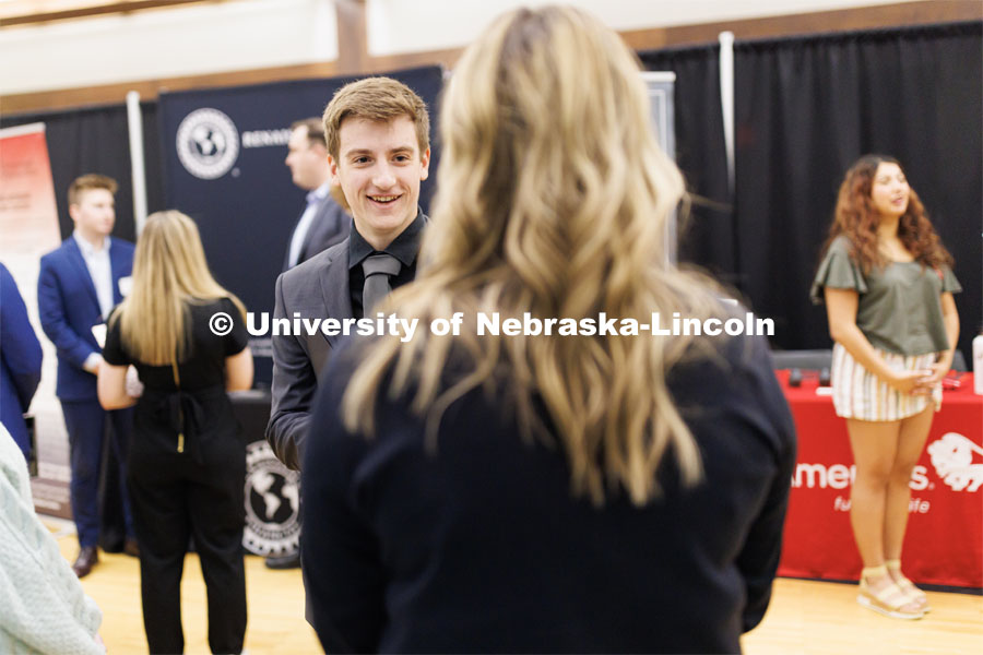 Tyler Mulliken talks with a recruiter from First Nebraska Bank at the Career and Internship Fair in Nebraska Union. February 27, 2023. Photo by Craig Chandler / University Communication.
