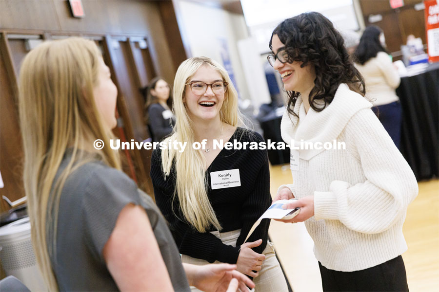 Gabby Gomez Martinez, right, and Kenidy Irvine talk with a recruiter from Charles Schwab during the Career and Internship Fair in Nebraska Union. February 27, 2023. Photo by Craig Chandler / University Communication.