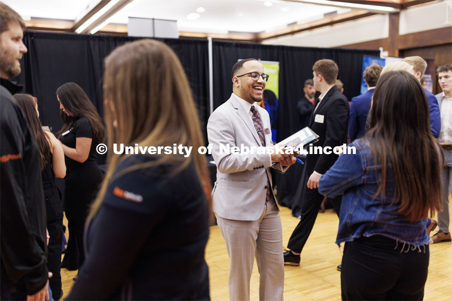 Ra’Daniel Arvie talks with a recruiter from NRC Health at the Career and Internship Fair in the Nebraska Union. February 28, 2023. Photo by Craig Chandler / University Communication.