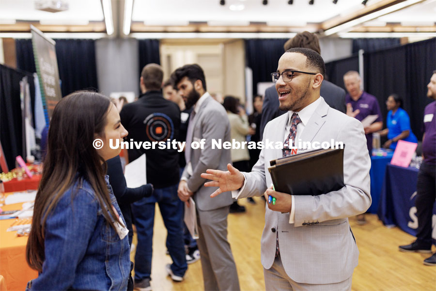 Ra’Daniel Arvie talks with a recruiter from NRC Health at the Career and Internship Fair in the Nebraska Union. February 28, 2023. Photo by Craig Chandler / University Communication.