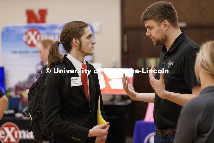 Christian Tietz talks with a recruiter from Landmark Implement at the Career and Internship Fair in the Nebraska Union. February 28, 2023. Photo by Craig Chandler / University Communication.