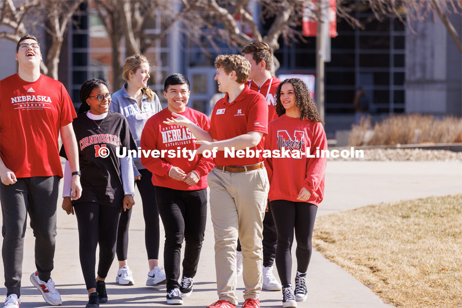 New Student Orientation Leader Jacob Vanderford leads a group across campus. NSE Leaders walking on campus with their student groups. New Student Orientation photo shoot for Orientation Leaders. February 28, 2023. Photo by Craig Chandler / University Communication.
