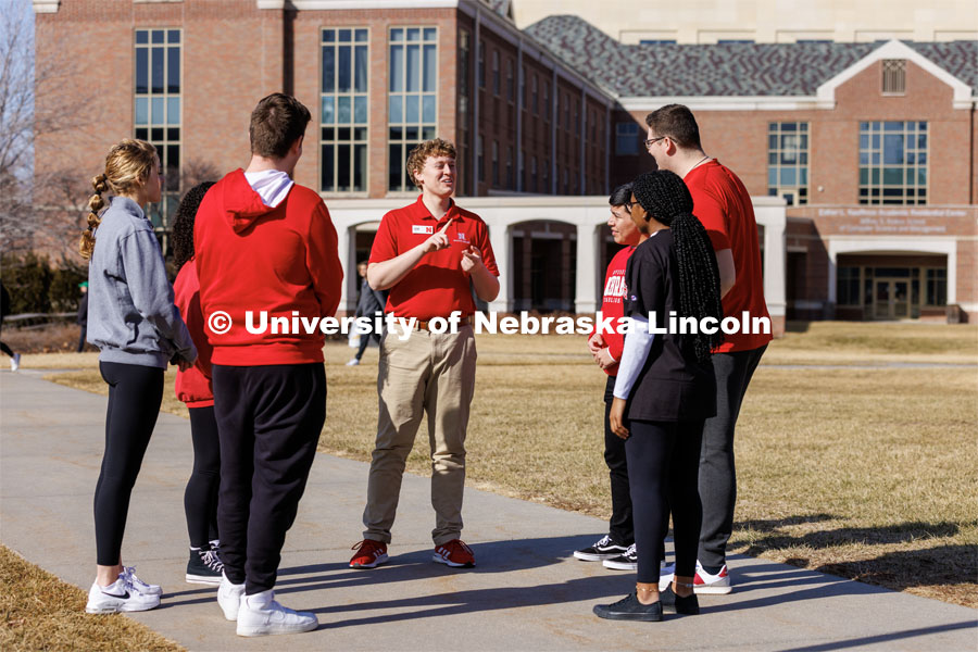 New Student Orientation Leader Jacob Vanderford leads a group across campus. NSE Leaders walking on campus with their student groups. New Student Orientation photo shoot for Orientation Leaders. February 28, 2023. Photo by Craig Chandler / University Communication.