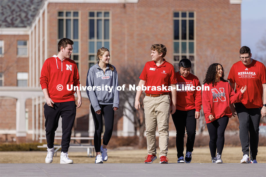 New Student Orientation Leader Jacob Vanderford leads a group across campus. NSE Leaders walking on campus with their student groups. New Student Orientation photo shoot for Orientation Leaders. February 28, 2023. Photo by Craig Chandler / University Communication.