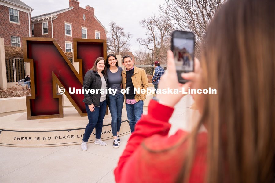 An out-of-state student and her family have their photo taken in-front of the Nebraska ’N’ during student admission’s National Tailgate at the Wick Alumni. Admitted Student Day is UNL’s in-person, on-campus event for all admitted students. March 24, 2023. Photo by Jordan Opp for University Communication.