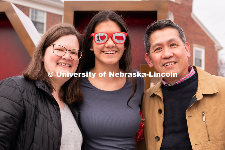 An out-of-state student and her family have their photo taken in-front of the Nebraska ’N’ during student admission’s National Tailgate at the Wick Alumni Center on Friday, March 24, 2023. during student admission’s National Tailgate at the Wick Alumni Center on Friday, March 24, 2023.  Photo by Jordan Opp for University Communication.