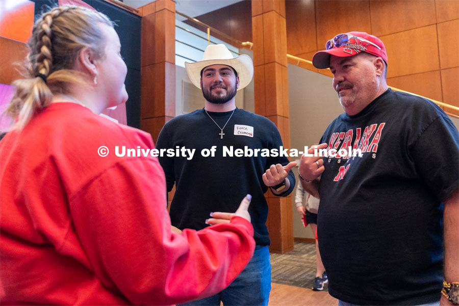University of Nebraska student representatives speak with out-of-state students and their families during student admission’s National Tailgate at the Wick Alumni Center on Friday, March 24, 2023. 
 Photo by Jordan Opp for University Communication.