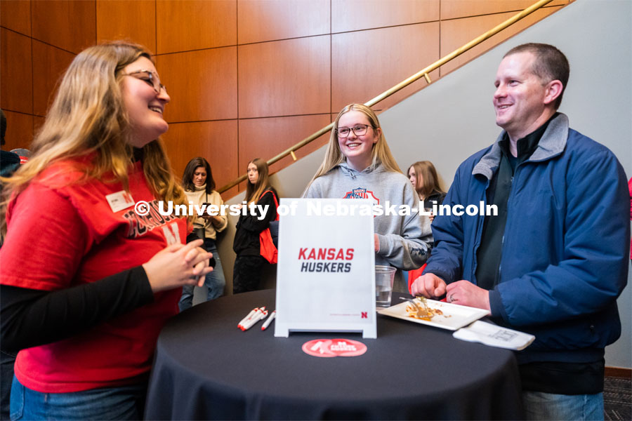 University of Nebraska student representatives speak with out-of-state students and their families during student admission’s National Tailgate at the Wick Alumni Center on Friday, March 24, 2023. 
 Photo by Jordan Opp for University Communication.