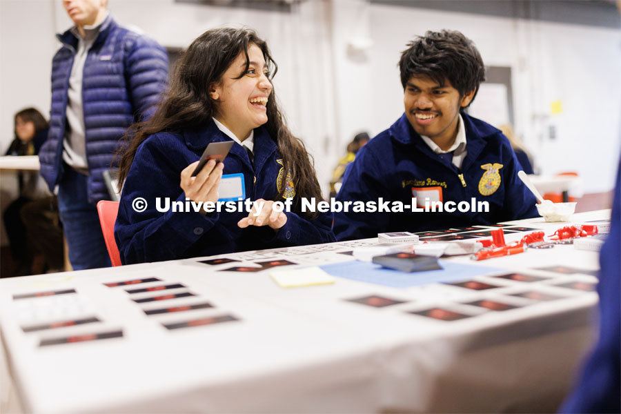 Fatima Pavila and Maximiliano from Omaha Bryant High School react as they play a card game with others. FFA pen pals from urban and rural schools meet face-to-face during the FFA state convention. March 29, 2023. Photo by Craig Chandler / University Communication.