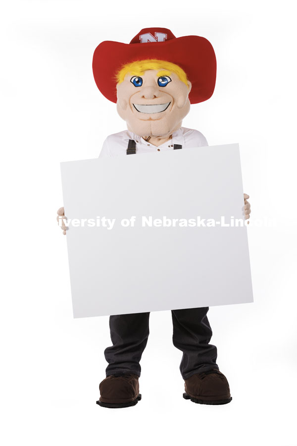Studio portrait of Herbie holding a white card. New Herbie photoshoot. April 7, 2023. Photo by Craig Chandler / University Communication.