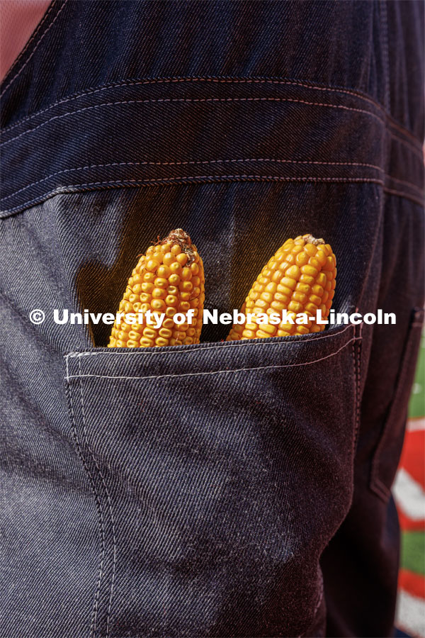 Ears of corn peak out of Herbie's back pocket. New Herbie photoshoot. April 7, 2023. Photo by Craig Chandler / University Communication.