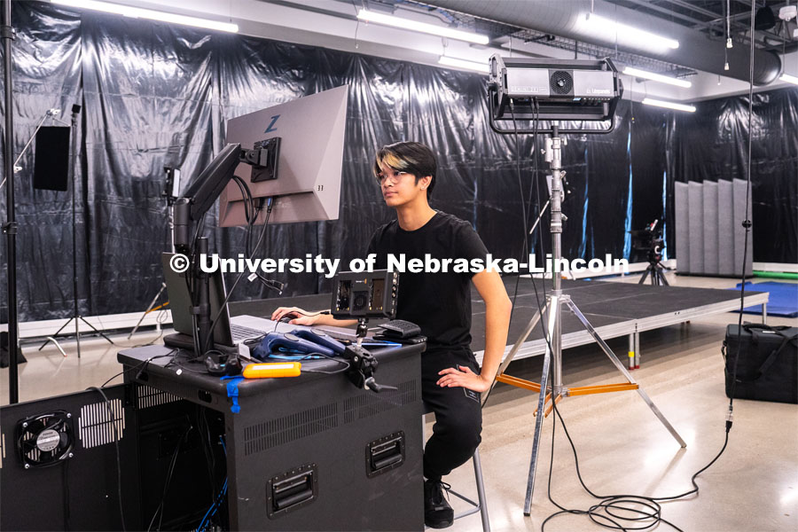 Sophomore emerging media arts major Xander Muniz prepares an environment in Unreal Engine that will be displayed on a screen behind him at the Johnny Carson Center for Emerging Media Arts. April 9, 2023. Photo by Jordan Opp for University Communication.