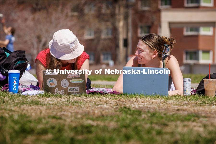 Amelia Collins, a freshman from Omaha, and Kyra George, a sophomore from Omaha, work on calculus homework outdoors. Spring on City Campus. April 10, 2023. Photo by Craig Chandler / University Communication.