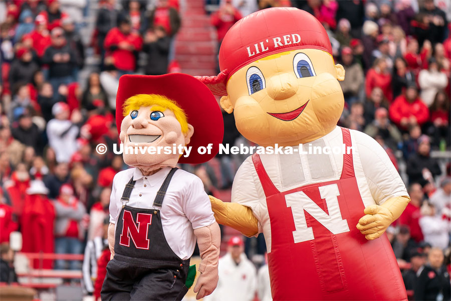 The new iteration of Herbie Husker, left, and Lil Red take the field before the Husker football spring game. April 22, 2023. Photo by Jordan Opp for University Communication.