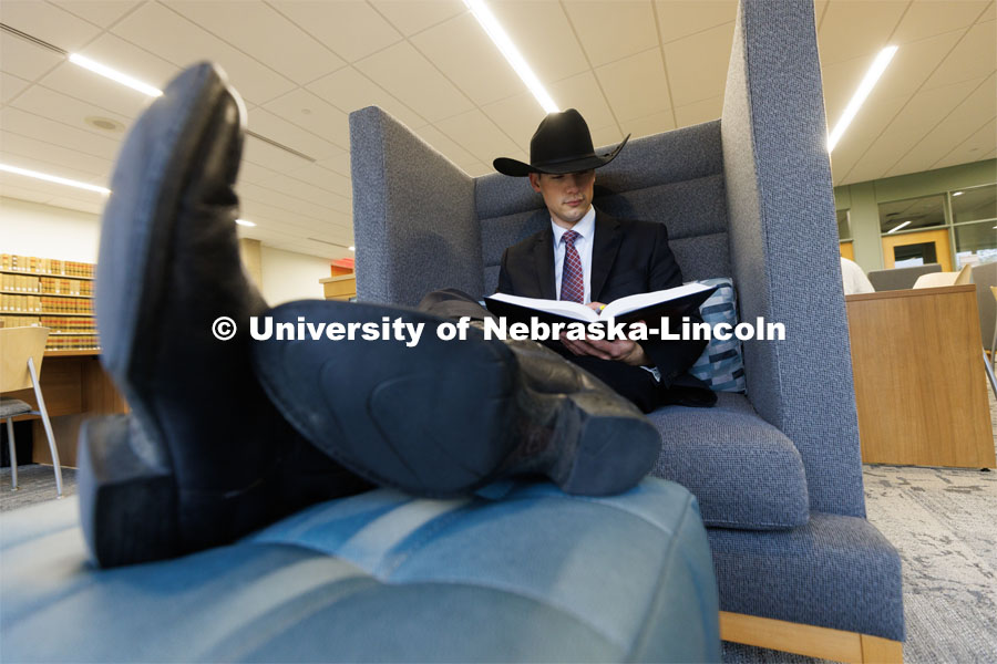 Students study in a private chair in the Law Library. College of Law photo shoot. April 28, 2023. Photo by Craig Chandler / University Communication.