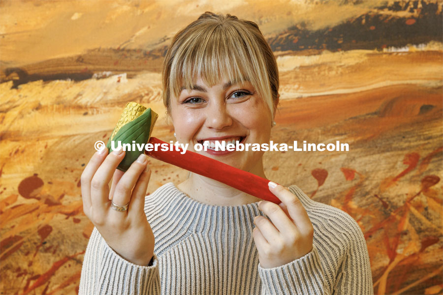 Emma Schlenker, a second-year law student, holds the corncob gavel she carved from an Eastern Cottonwood, the Nebraska state tree. College of Law photo shoot. April 28, 2023. Photo by Craig Chandler / University Communication.