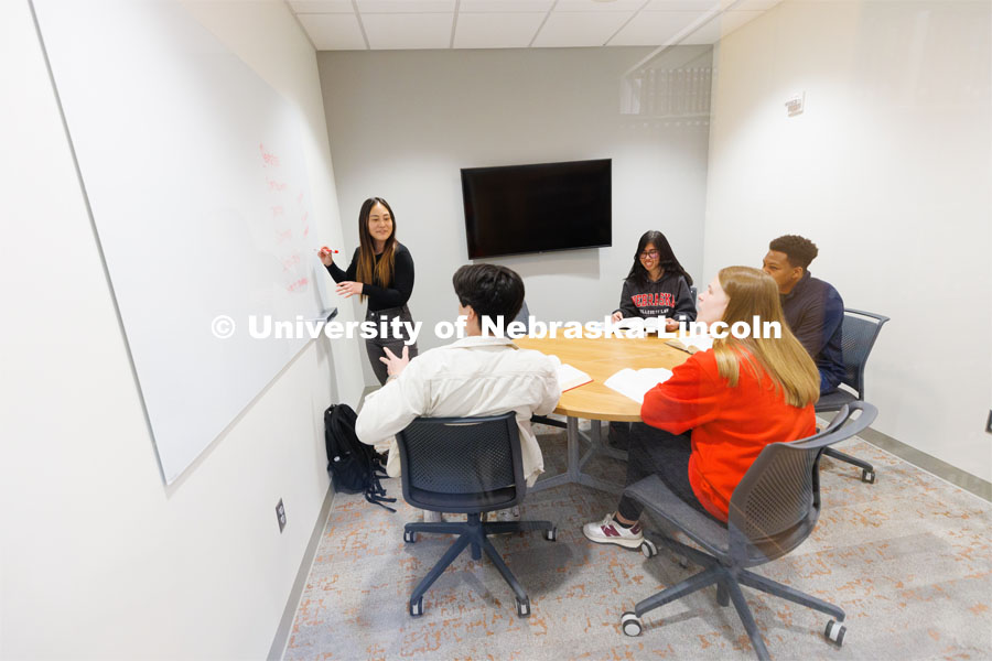 Students use a marker board while studying in a study room. College of Law photo shoot. April 28, 2023. Photo by Craig Chandler / University Communication.
