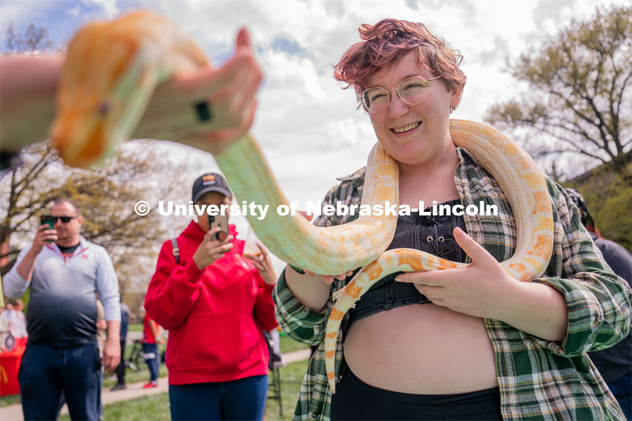 Junior Psychology major Hazel O’Shea smiles as a snake is placed around her neck at the 2023 End of Year Bash at East Campus Mall. April 29, 2023. Photo by Jordan Opp for University Communication.