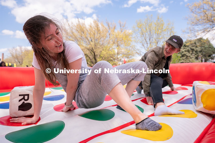 Junior Human Development and Family Sciences major Molly Storm, left, and senior Mechanical Engineering major Chase Pettit play a game of Twister at the 2023 End of Year Bash at East Campus Mall. April 29, 2023. Photo by Jordan Opp for University Communication.