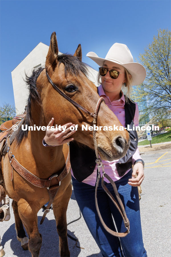 Jadyn Fleischman talks with her horse outside Hawks Hall after unloading it from the horse trailer. Students in Rob Simon’s capstone marketing course held a promotional event for the UNL rodeo on the west side of the Union on Monday. The class developed a marketing strategy for the Rodeo Club to help promote their upcoming rodeo. Seven horses and multiple club members were on city campus for students to meet, get close to and have their photos taken. May 1, 2023. Photo by Craig Chandler / University Communication.