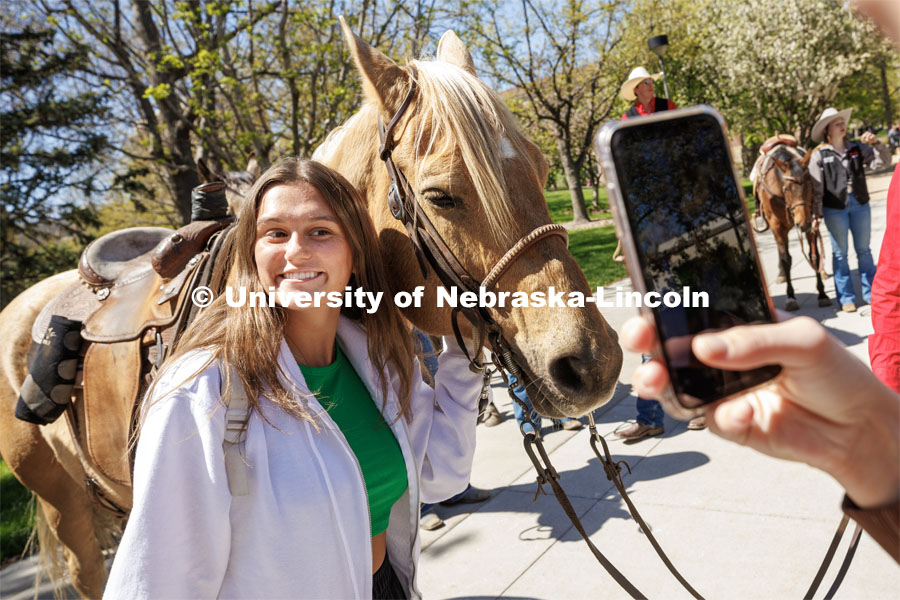 Bella Rodriguez, a sophomore from Kansas City, Missouri, poses for a photo at the event. Students in Rob Simon’s capstone marketing course held a promotional event for the UNL rodeo on the west side of the Union on City Campus. The class developed a marketing strategy for the Rodeo Club to help promote their upcoming rodeo. Seven horses and multiple club members were on city campus for students to meet, get close to and have their photos taken. May 1, 2023. Photo by Craig Chandler / University Communication.
