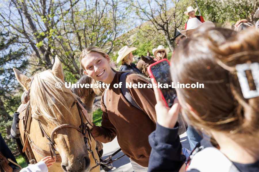 Grace Macklin, a sophomore from Roca, Nebraska, poses for a photo at the event. Students in Rob Simon’s capstone marketing course held a promotional event for the UNL rodeo on the west side of the Union on City Campus. The class developed a marketing strategy for the Rodeo Club to help promote their upcoming rodeo. Seven horses and multiple club members were on city campus for students to meet, get close to and have their photos taken. May 1, 2023. Photo by Craig Chandler / University Communication.