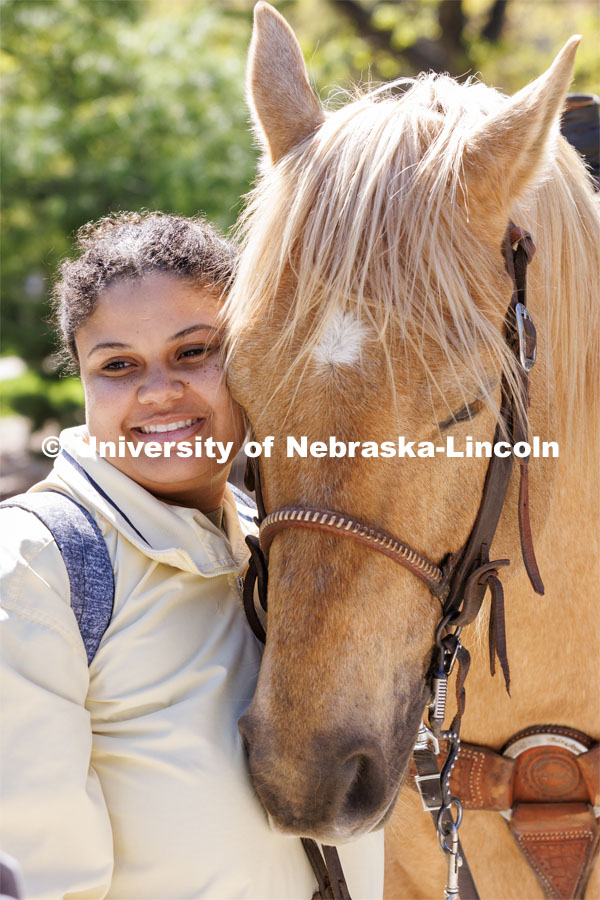 Rachel Freeman, a junior from Des Moines, poses so her friend can take her photo with a horse. Students in Rob Simon’s capstone marketing course held a promotional event for the UNL rodeo on the west side of the Union on City Campus. The class developed a marketing strategy for the Rodeo Club to help promote their upcoming rodeo. Seven horses and multiple club members were on city campus for students to meet, get close to and have their photos taken. May 1, 2023. Photo by Craig Chandler / University Communication.