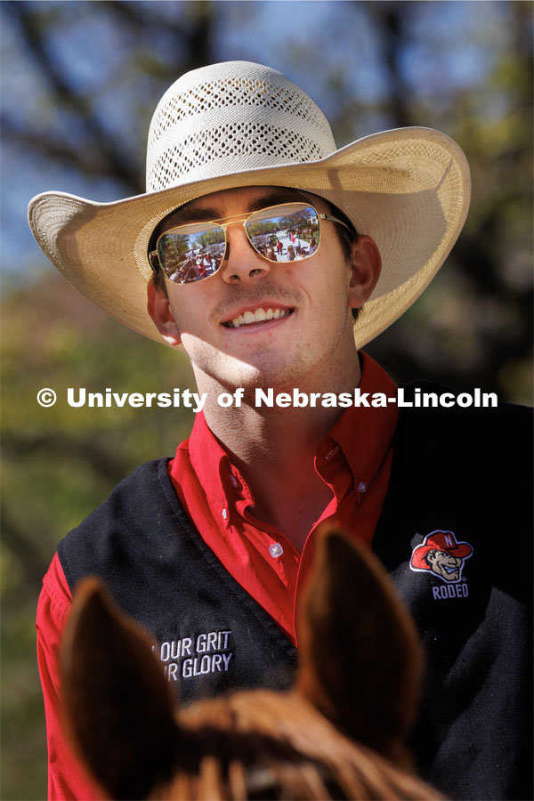 The horses and students are reflected in the sunglasses of Rodeo Club member Josiah Kamler. Students in Rob Simon’s capstone marketing course held a promotional event for the UNL rodeo on the west side of the Union on City Campus. The class developed a marketing strategy for the Rodeo Club to help promote their upcoming rodeo. Seven horses and multiple club members were on city campus for students to meet, get close to and have their photos taken. May 1, 2023. Photo by Craig Chandler / University Communication.