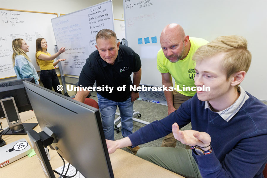 Erik Konnath, right, talks with members of the Allo team, Ed Jarrett and Jon McHenry (in yellow t-shirt) as they discuss the project. In the background from left are Design Studio team members Sophie Hill and Hannah Pokharel. May 2, 2023. Photo by Craig Chandler / University Communication.