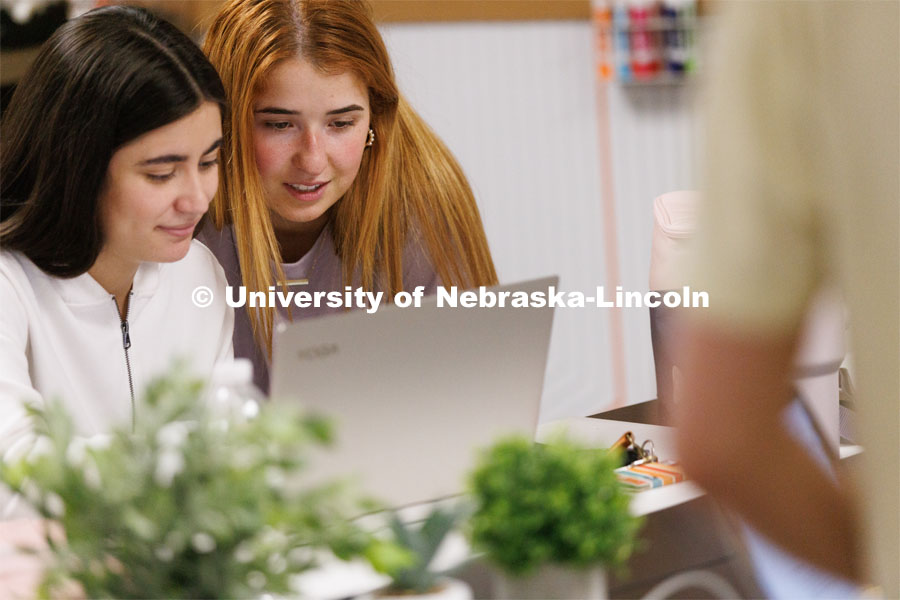 Valeria Uribe and Hannah Kate Kinney look over their project at the Jacht Ad Agency. May 10, 2023. Photo by Craig Chandler / University Communication.