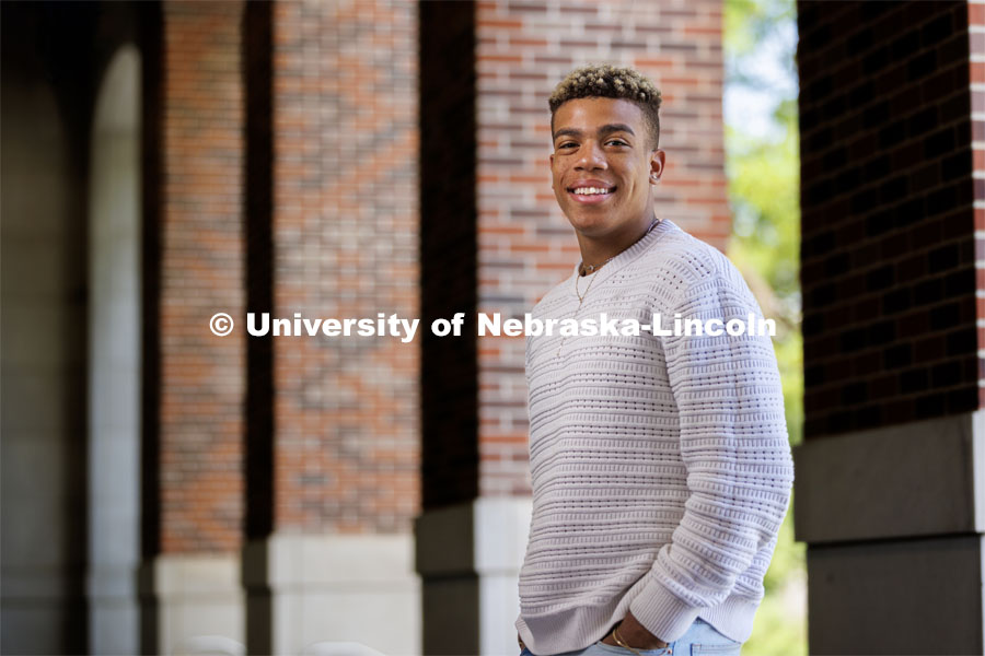 Sam Phillips, senior in Hospitality, Restaurant and Tourism Management and Husker Dialogue speaker is photographed by the columns of the Nebraska Union. Husker Dialogue photo shoot. May 18, 2023. Photo by Craig Chandler / University Communication.