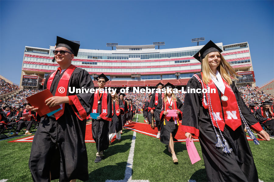 Arts and Science graduates walk toward the stage. Undergraduate commencement at Memorial Stadium. May 20, 2023. Photo by Craig Chandler / University Communication.



