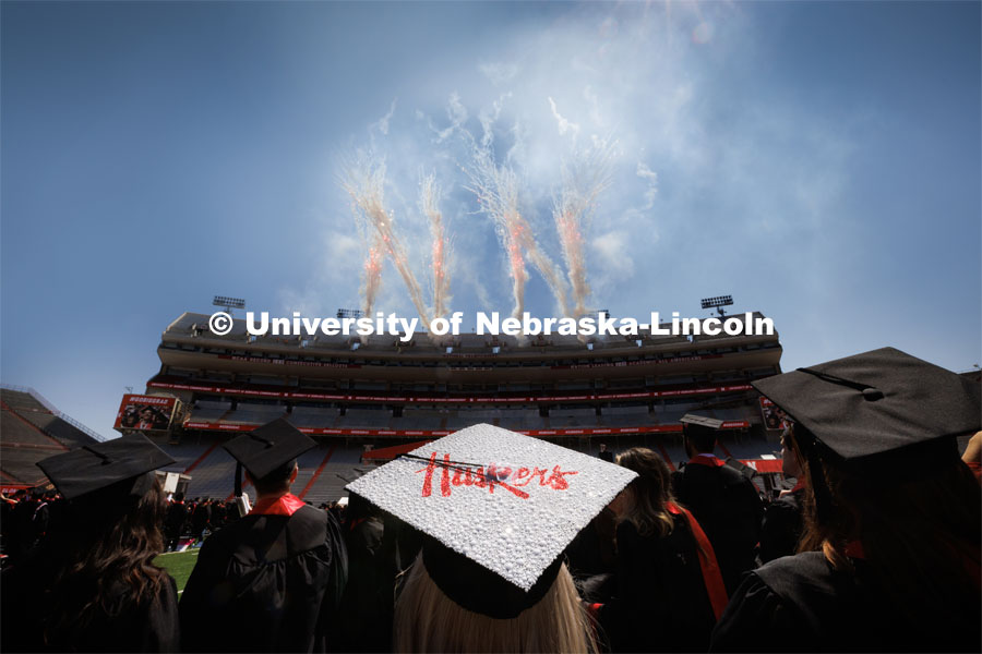 THIS PHOTO FOR MARKETING PURPOSES ONLY.  In original photo, fireworks company reversed the N as viewed from inside the stadium. Ashtyn Tridle watches the fireworks at the conclusion of commencement. Undergraduate commencment at Memorial Stadium. May 20, 2023. Photo by Craig Chandler / University Communication. 