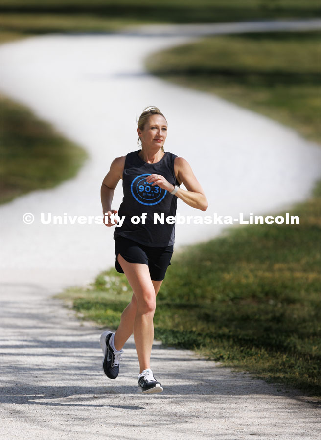 Dean Shari Veil trains along the paths at Holmes Lake. She runs marathons. College of Journalism and Mass Communication. Downtime with the Deans series for Alumni Magazine. May 30, 2023. Photo by Craig Chandler / University Communication.