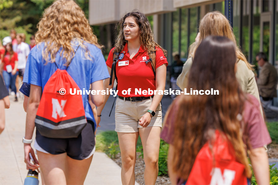 Orientation Leader Crystal Carrillo leads her group across campus. New Student Enrollment ( NSE ) on City Campus. June 13, 2023. Photo by Craig Chandler / University Communication.