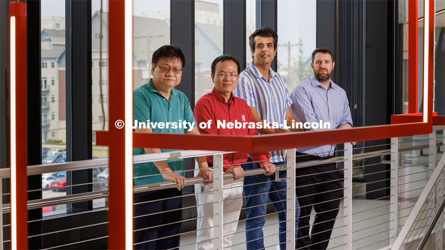 Nebraska Engineering researchers (from left) Yongfeng Lu, Bai Cui, Piyush Grover, and Keegan Moore are on teams that received three-year, $600,000 grants from the Defense Established Program to Stimulate Competitive Research (DEPSCoR). The group are posed in the Engineering Research Center. June 27, 2023. Photo by Craig Chandler / University Communication.