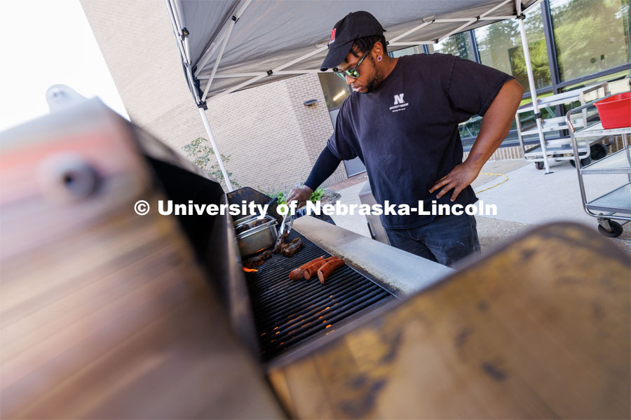 Sean Jones, a line cook with dining services, flips short ribs on the grill before serving them to customers. East Campus Dining’s Summer Grill Outs include Oklahoma BBQ today. July 20, 2023. Photo by Craig Chandler / University Communication.
