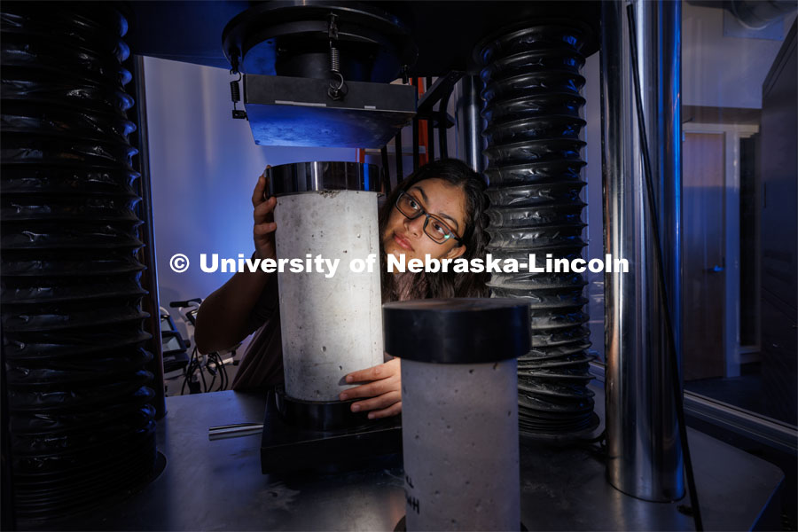 Doreen Rahman sets up a compression test for a concrete sample. She is a masters student in mechanical engineering and works in Cody Stolle’s lab in Whittier. July 27, 2023. Photo by Craig Chandler / University Communication.