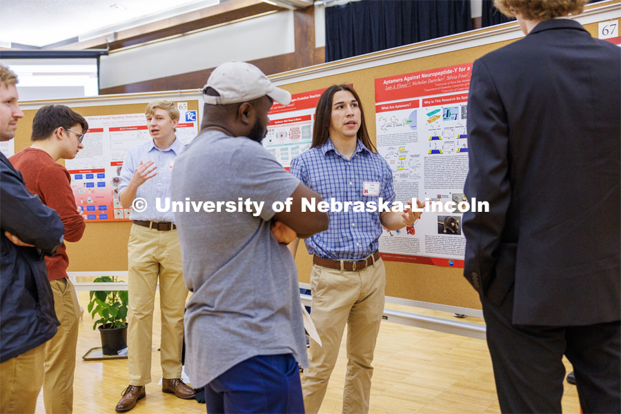 Luis Flores of University of Texas San Antonio discusses his poster. Summer Undergraduate Research Fair poster session in the Nebraska Union Ballroom. August 3, 2023. Photo by Craig Chandler/ University Communication.