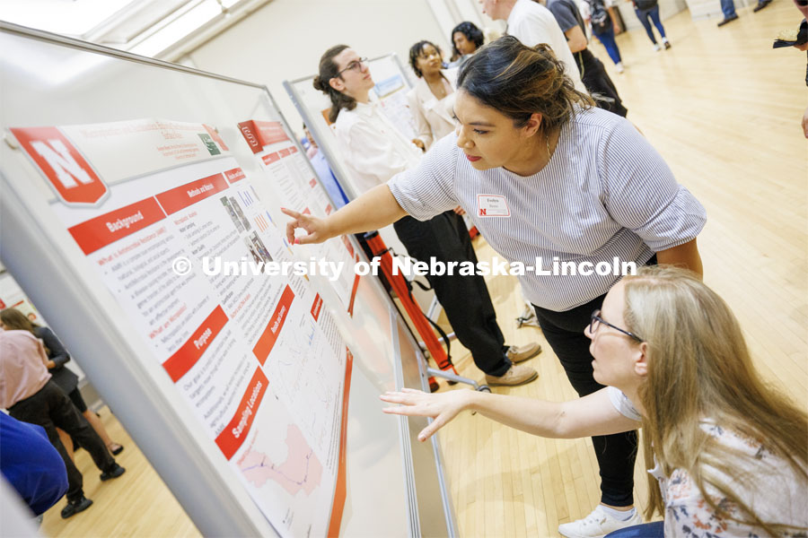 Evelyn Reyes discusses her civil and environmental engineering poster. Summer Undergraduate Research Fair poster session in the Nebraska Union Ballroom. August 3, 2023. Photo by Craig Chandler/ University Communication.
