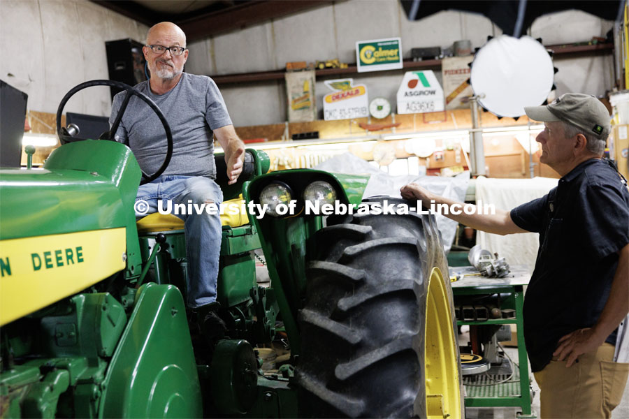 Richard Endacott gestures to producer Jamie Vesay as they discuss whether a restored tractor should be started during the filming. Filming of the movie using UNL students as the production crew. Richard Endacott earned multiple awards for his screenplay, "Turn Over." Story about keeping the family farm operating in the modern era as two brothers come together via restoring an old tractor to help fund their operations. August 9, 2023. Photo by Craig Chandler / University Communication.
